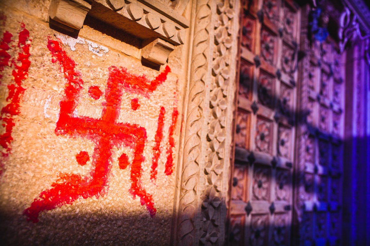 The swastika means you well. Swastika or Lucky Charm. In Sanskrit: su "well" asti "being" ka "making". The oldest found has been dated as early as 10,000 BC. In 1920 it was adopted by the Nazi party to symbolize the Aryan race, stigmatizing the sign as associated with antisemitism, hatred, death and murder. In India, painted next to a door, it's still an auspicious sign and an invitation to the gods. Jaisalmer, India, 2014.