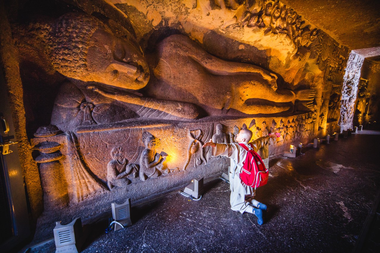 I was going from caves to caves, there were very few foreign visitors. I met Suky around cave no26, a nun from Korea, she was very exited to be here. She had two cellphones and a tablet, she's a connected nun. Ajanta, Maharashtra, India, 2014.