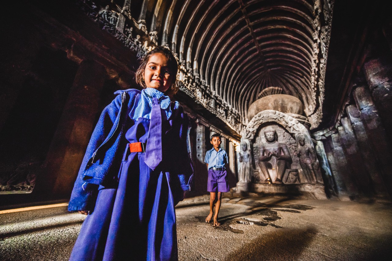 Back to school. I was setting up my tripod and checking my focus when those two subject decided my camera was certainly more interesting than the more than 1300 years old carved cave and statues around. I pulled the focus a bit closer, then triggered. Ellora Caves. Maharashtra, India, 2014.