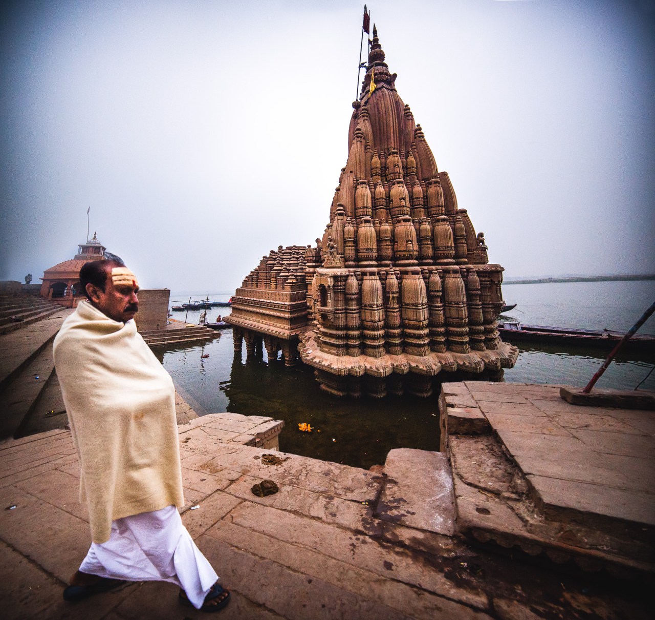 Mandir. A Hindu temple is a house of gods. It is a space to bring human beings and gods together. A temple incorporates all elements of Hindu cosmos presenting the good, the evil and the human, as well as the elements of Hindu sense of cyclic time and the essence of life - symbolically presenting dharma, kama, artha, moksa and karma. Varanasi, Uttar Pradesh, India, 2014.