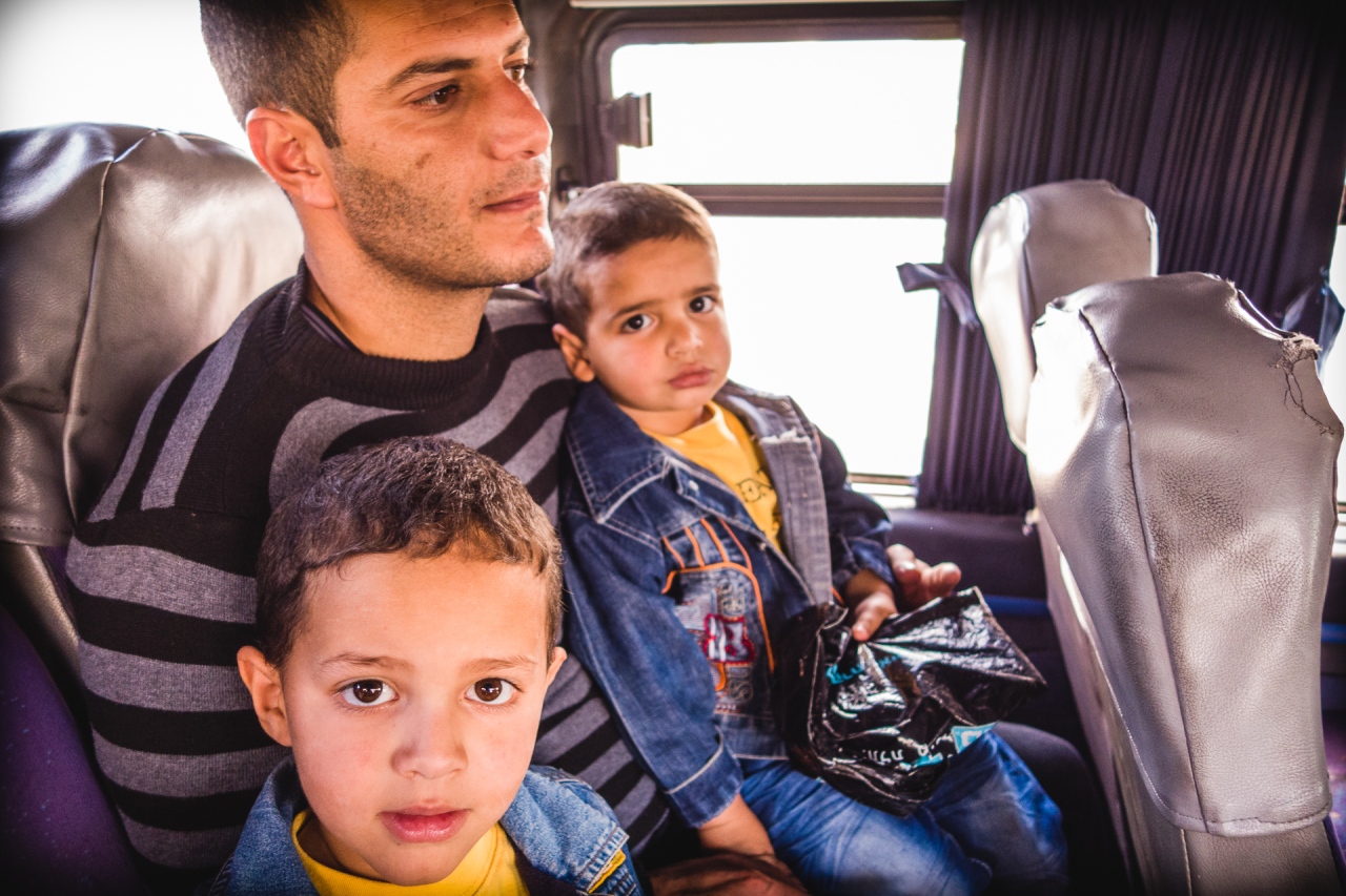 A father with his two sons in the bus to Bethlehem. Bethlehem, Palestine, 2014.