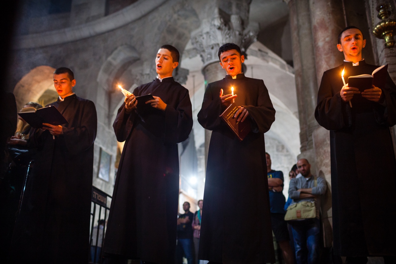 A prayer in the Church of the Holy Sepulchre in the center of the Old Jerusalem. Jerusalem, Israel, 2014.